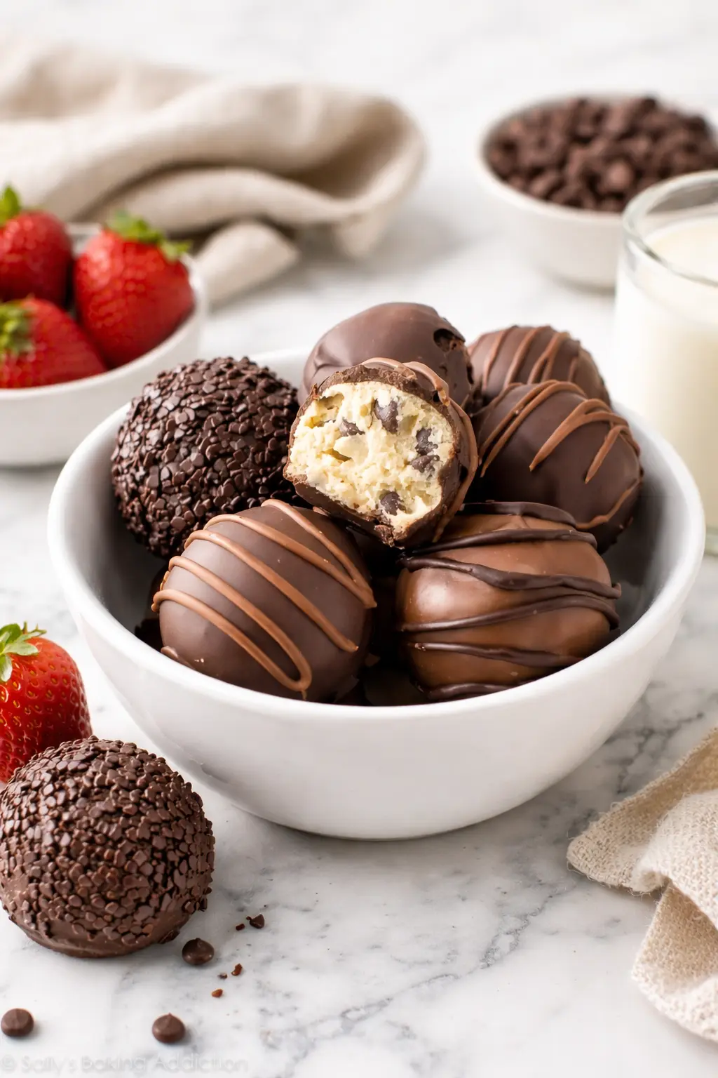 Cookie Dough Truffles served in a white bowl with chocolate coating and a soft cookie dough center, ready to eat