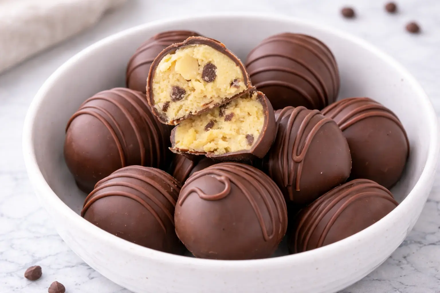 Chocolate Chip Cookie Dough Truffles coated in chocolate with a soft cookie dough center, ready to serve
