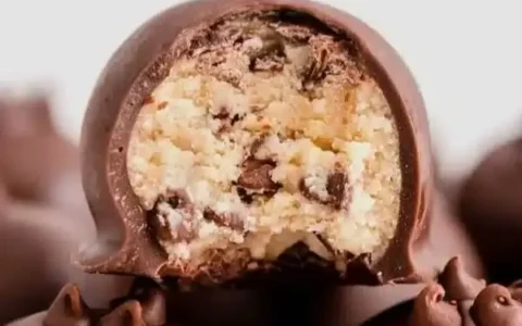 Cookie dough truffles coated in chocolate with a soft cookie dough center, ready to serve