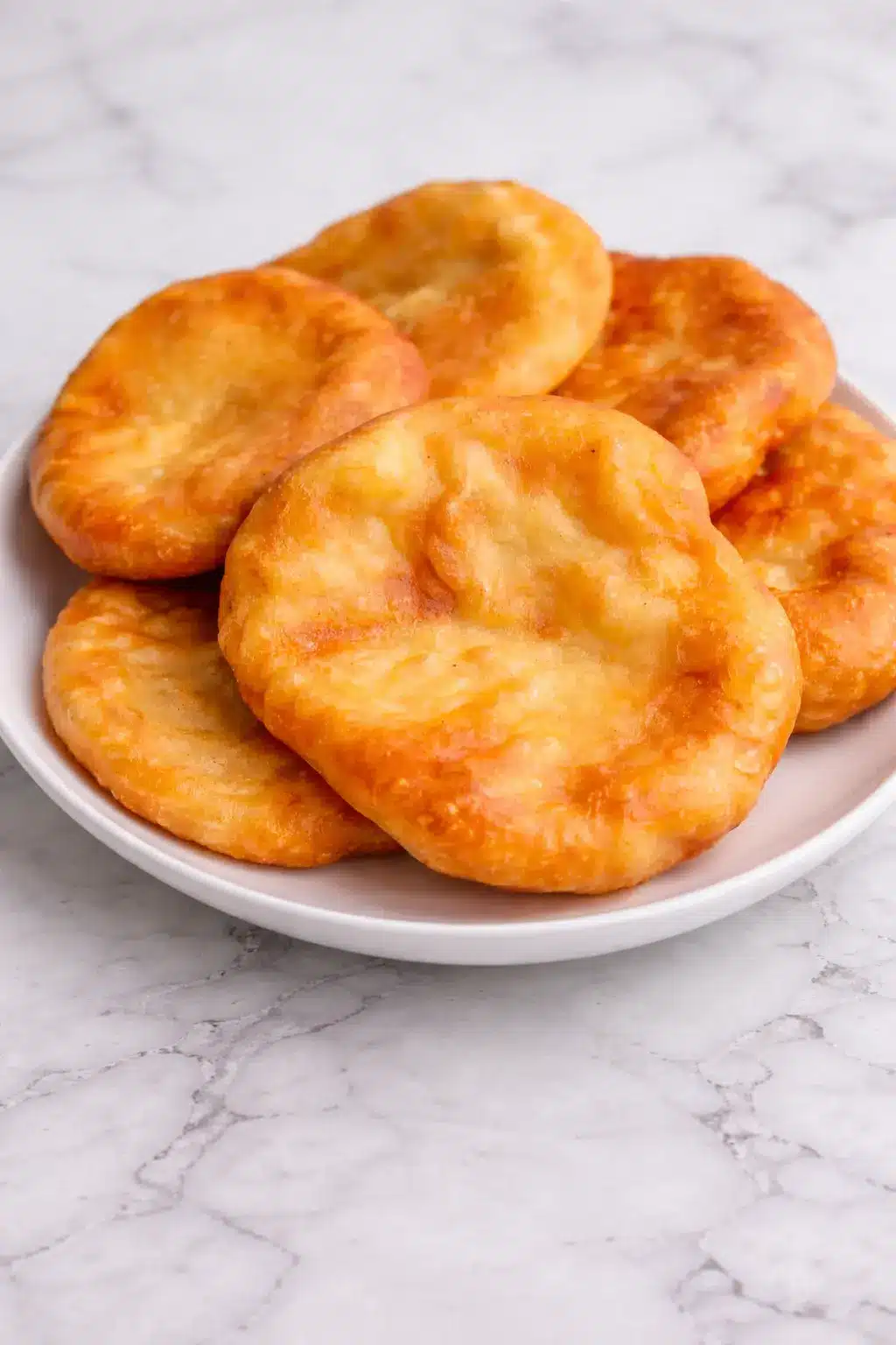 Indian Fry Bread Indian fry bread freshly cooked and stacked on a white plate