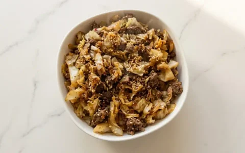 Photorealistic low carb high protein meal on white marble, naturally plated, freshly cooked and ready to serve.