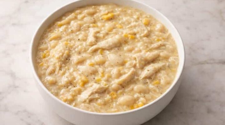 Creamy white chicken chili with shredded chicken, white beans, and corn served in a white bowl