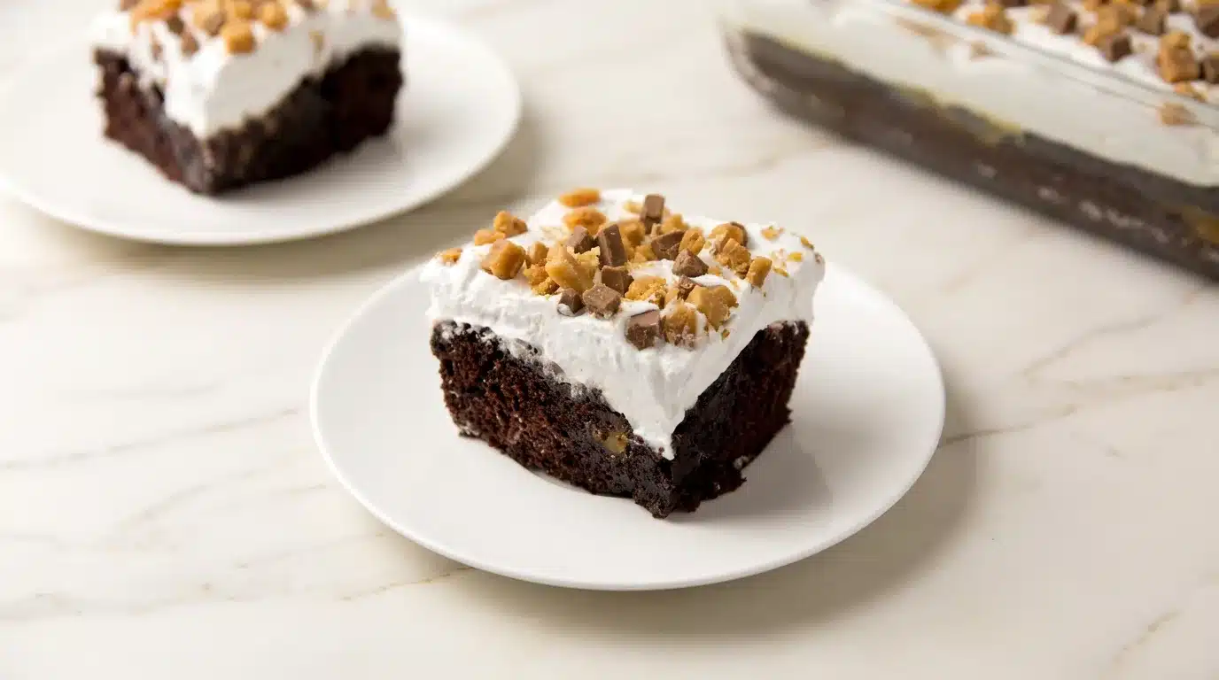 Photorealistic Better Than Sex Cake, ready to serve, on white marble. Overhead, 16x9. Naturally plated, rich and decadent dessert.