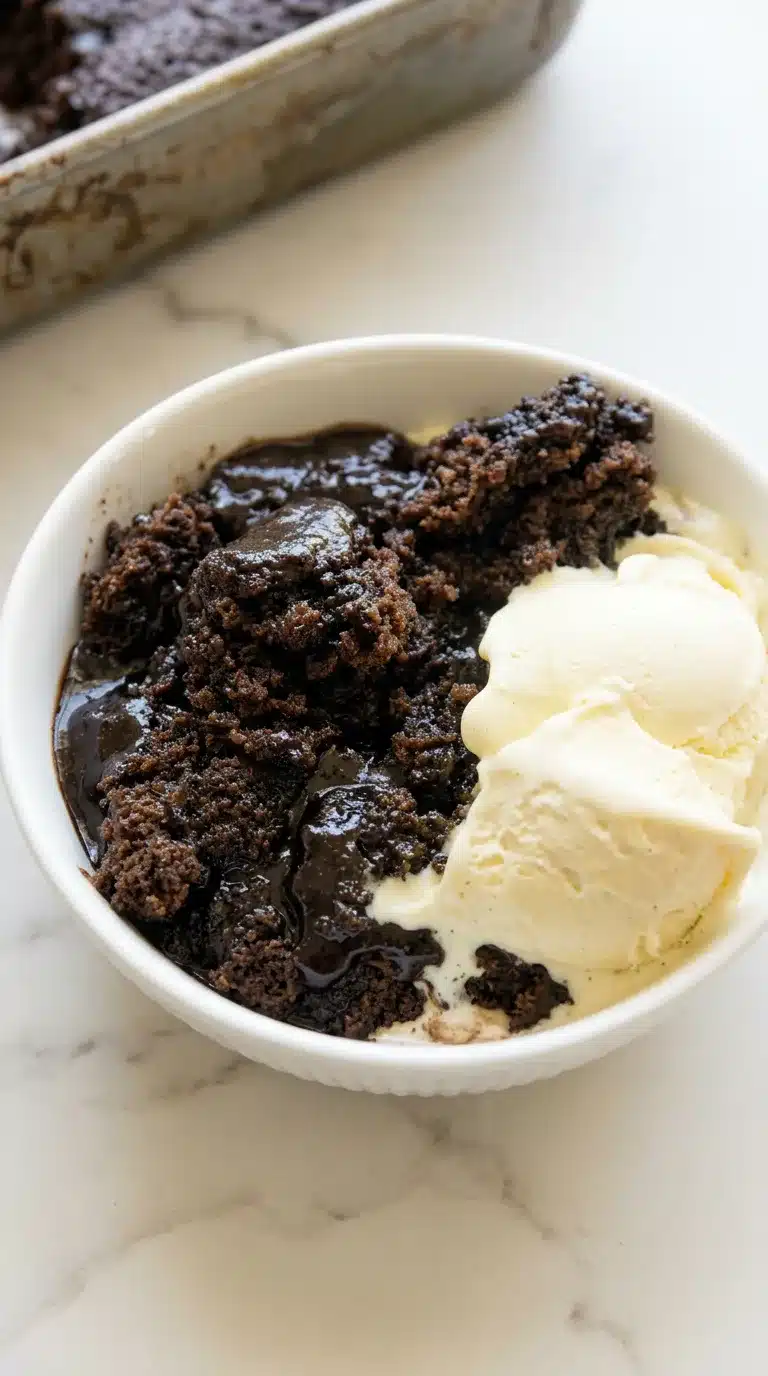 Chocolate Cobbler Photorealistic Chocolate Cobbler, freshly cooked and ready to serve, naturally plated on clean white marble with natural daylight.