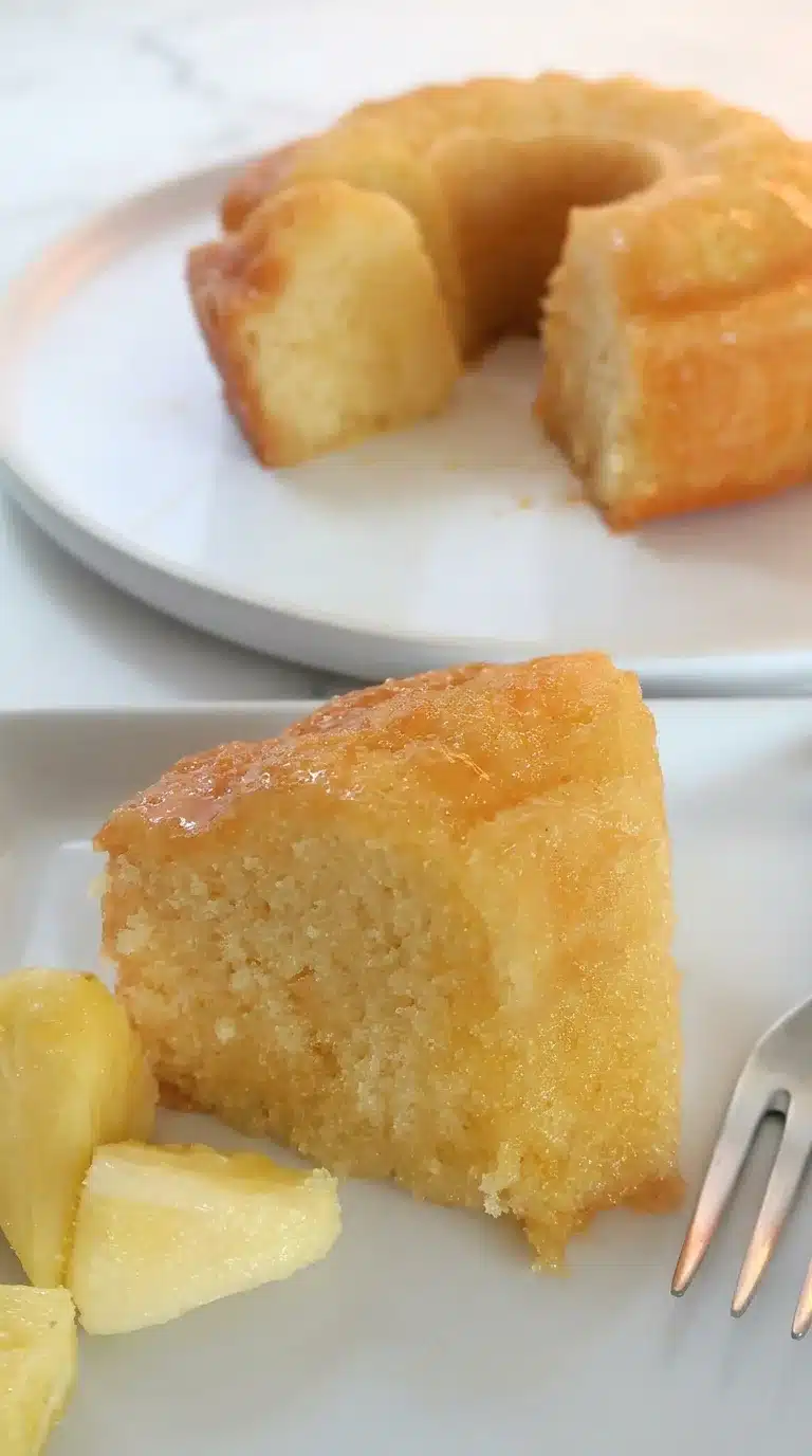 Pineapple Juice Cake Photorealistic Pineapple Juice Cake, naturally plated, freshly cooked, ready to serve on white marble with natural daylight.