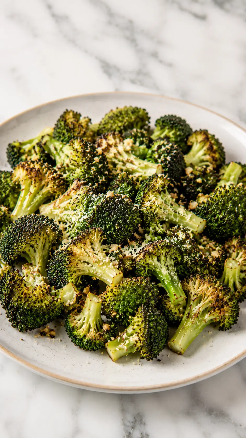 Crispy Garlic Parmesan Roasted Broccoli Crispy Garlic Parmesan Roasted Broccoli on White Marble Plate